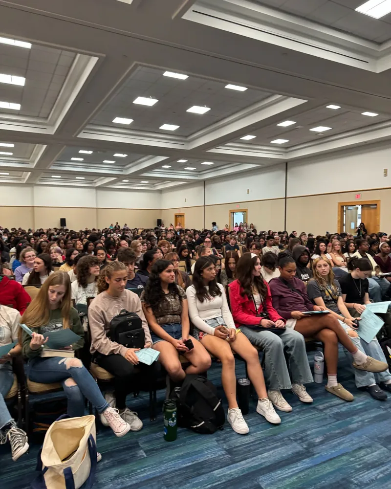 A full ballroom of students at the festival