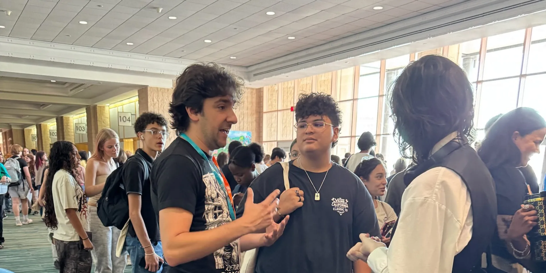 Students and authors mingling by the balloon arch at the 2025 festival