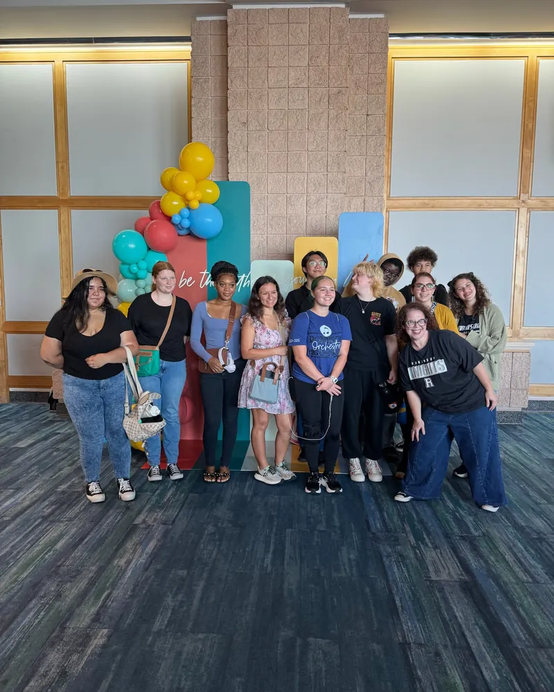 A group of students under the balloon arch