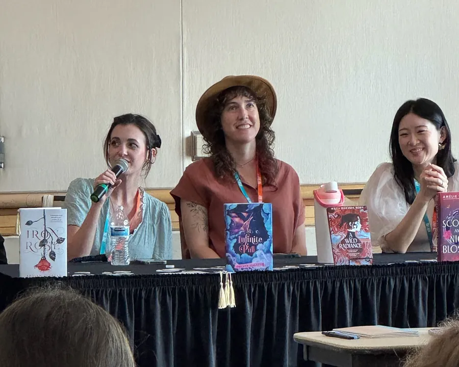Three authors on a panel, one of them speaking