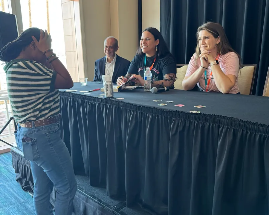 A student at the microphone asking the authors on the panel a question